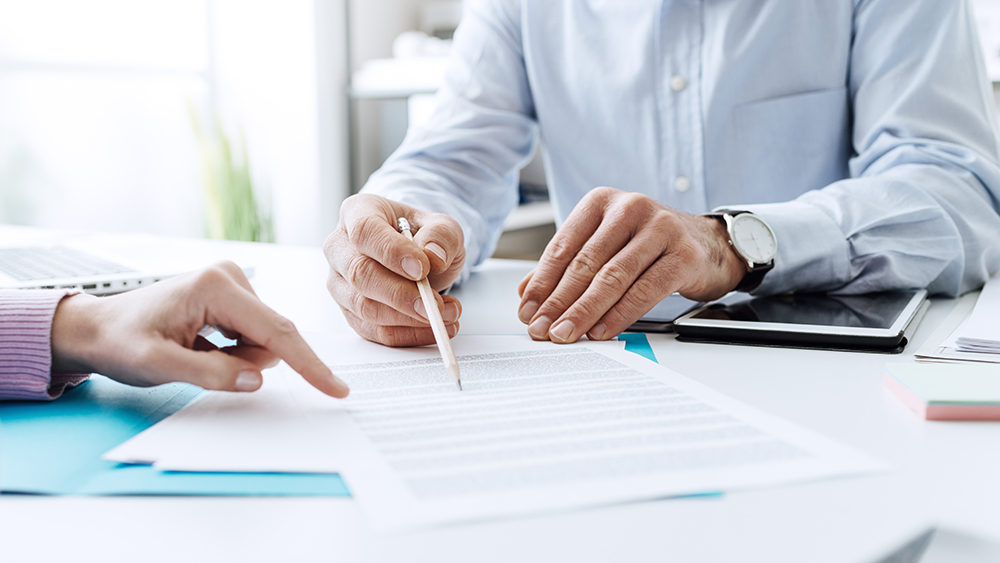 Two agents going over the paperwork